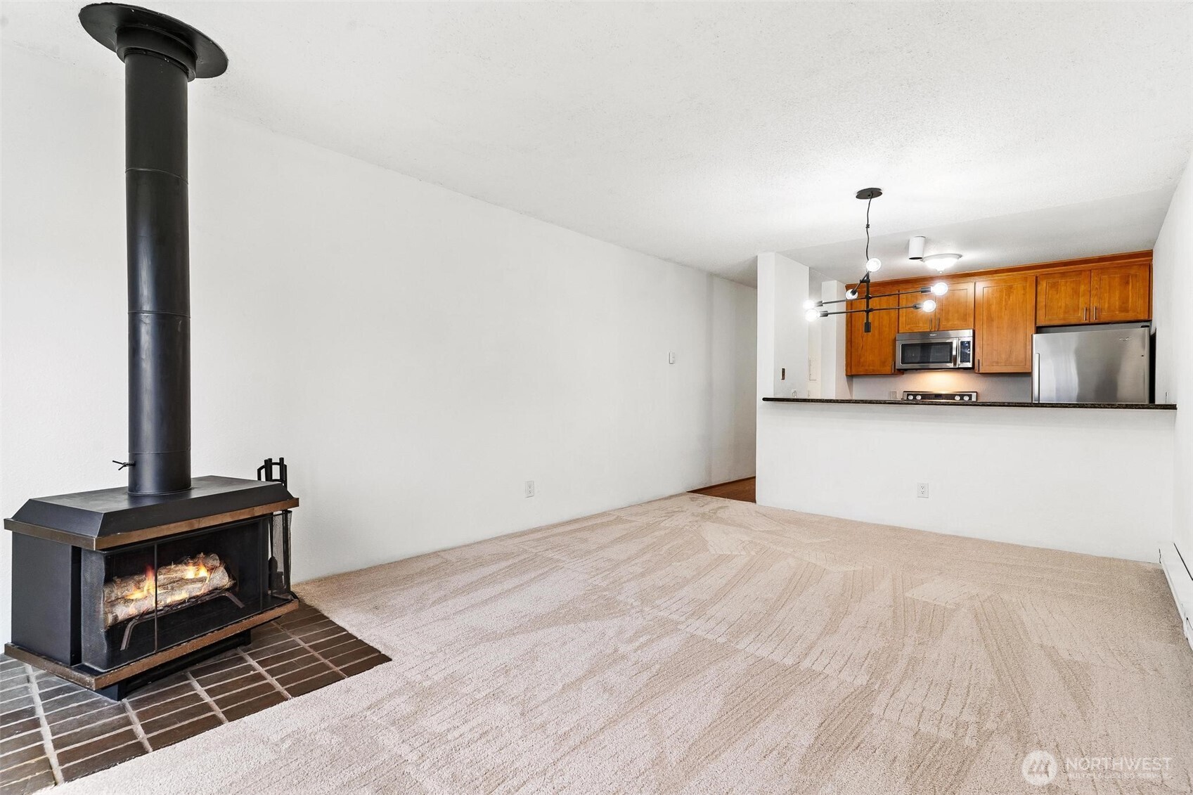 5832 Northeast 75th Street, Unit E304 Seattle, WA 98115 - Photo 15 of 36 a view of a kitchen with a sink and a fireplace
