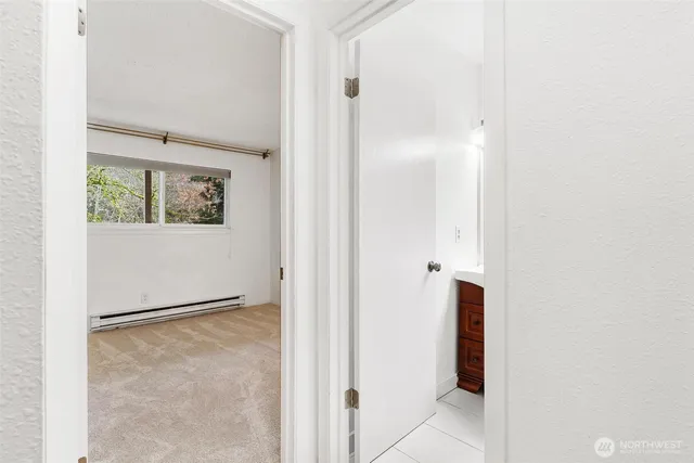 a view of a bathroom from a hallway