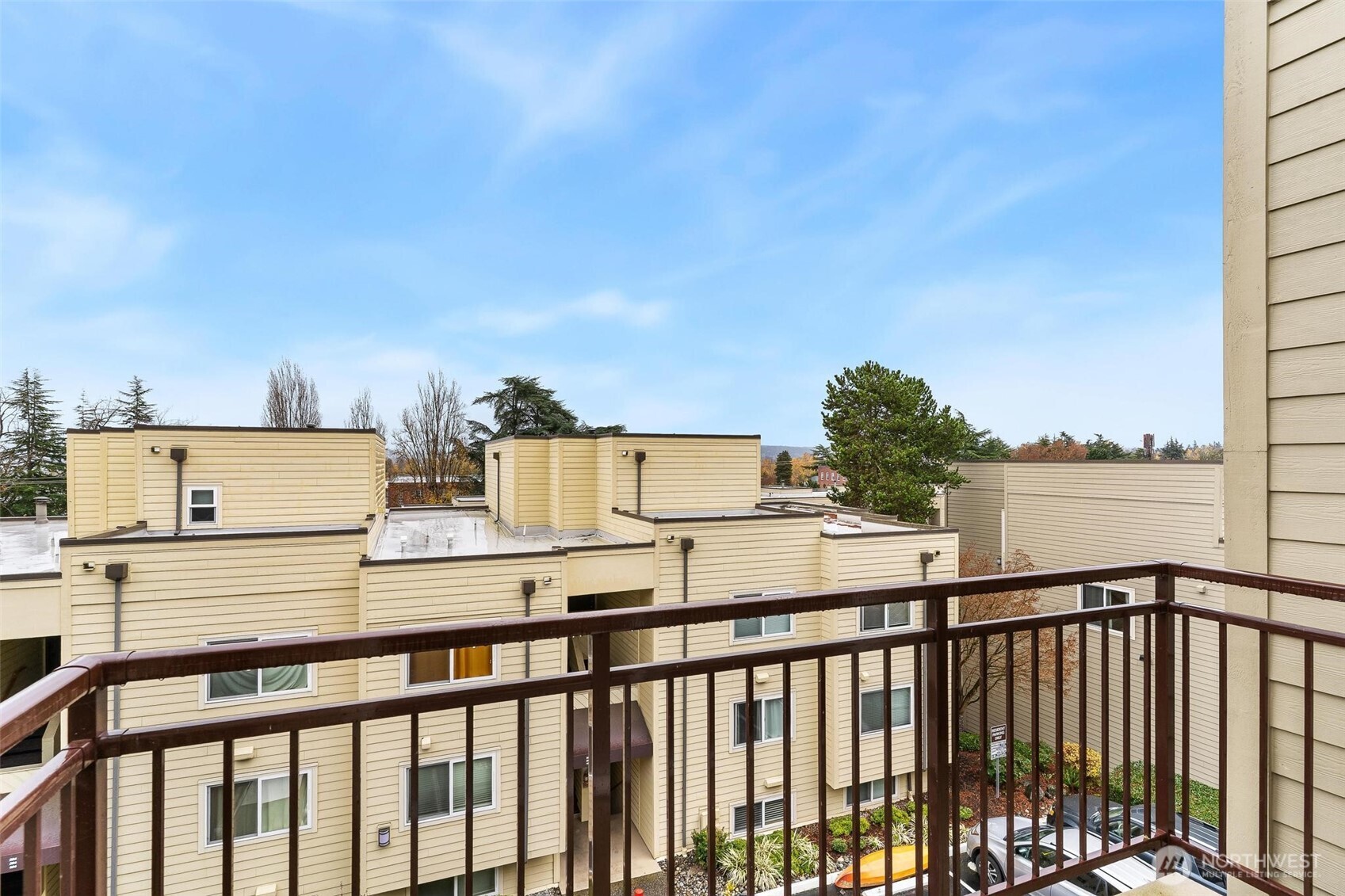 5832 Northeast 75th Street, Unit E304 Seattle, WA 98115 - Photo 26 of 36 a view of a balcony with wooden fence and floor