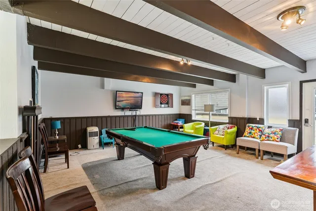 a living room with furniture a wooden floor and next to a window