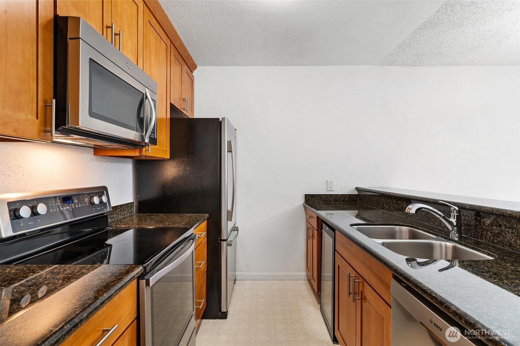 5832 Northeast 75th Street, Unit E304 Seattle, WA 98115 - Photo 4 of 36 a kitchen with a sink stove and microwave