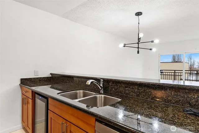 a kitchen that has a sink a stove and a wooden floor