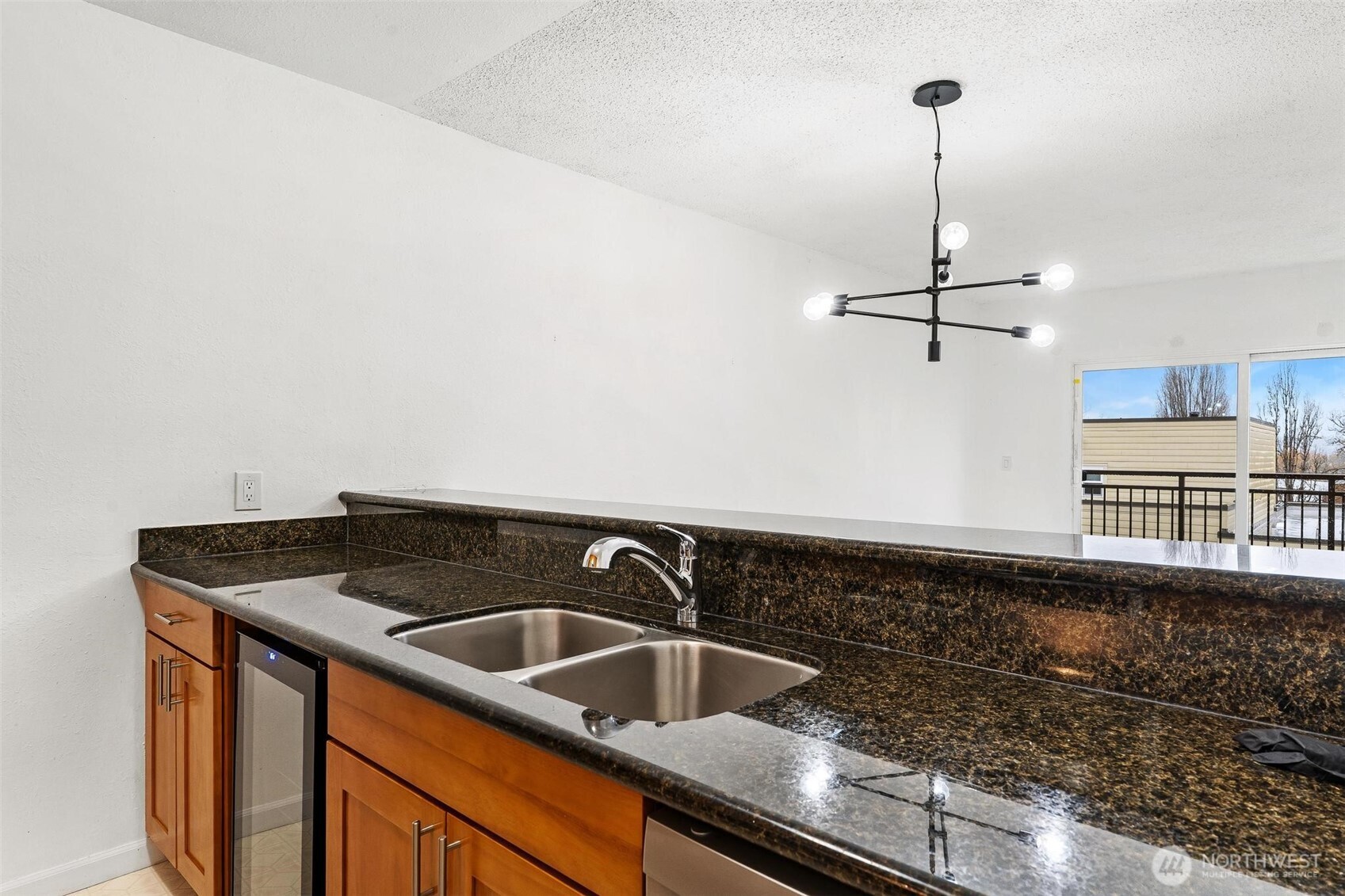 5832 Northeast 75th Street, Unit E304 Seattle, WA 98115 - Photo 5 of 36 a kitchen that has a sink a stove and a wooden floor