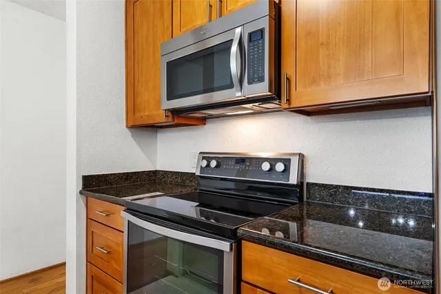 a kitchen with wooden cabinets and a stove top oven
