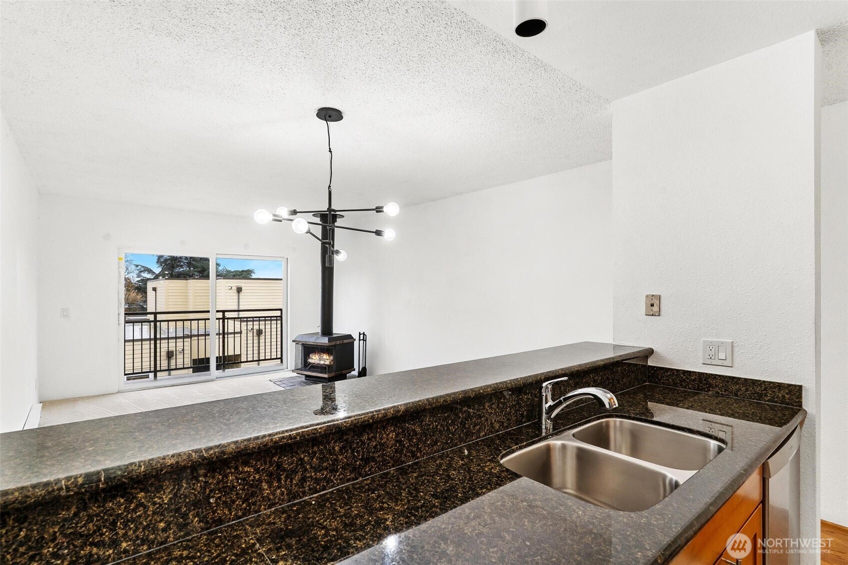 5832 Northeast 75th Street, Unit E304 Seattle, WA 98115 - Photo 8 of 36 a kitchen with a sink and chandelier