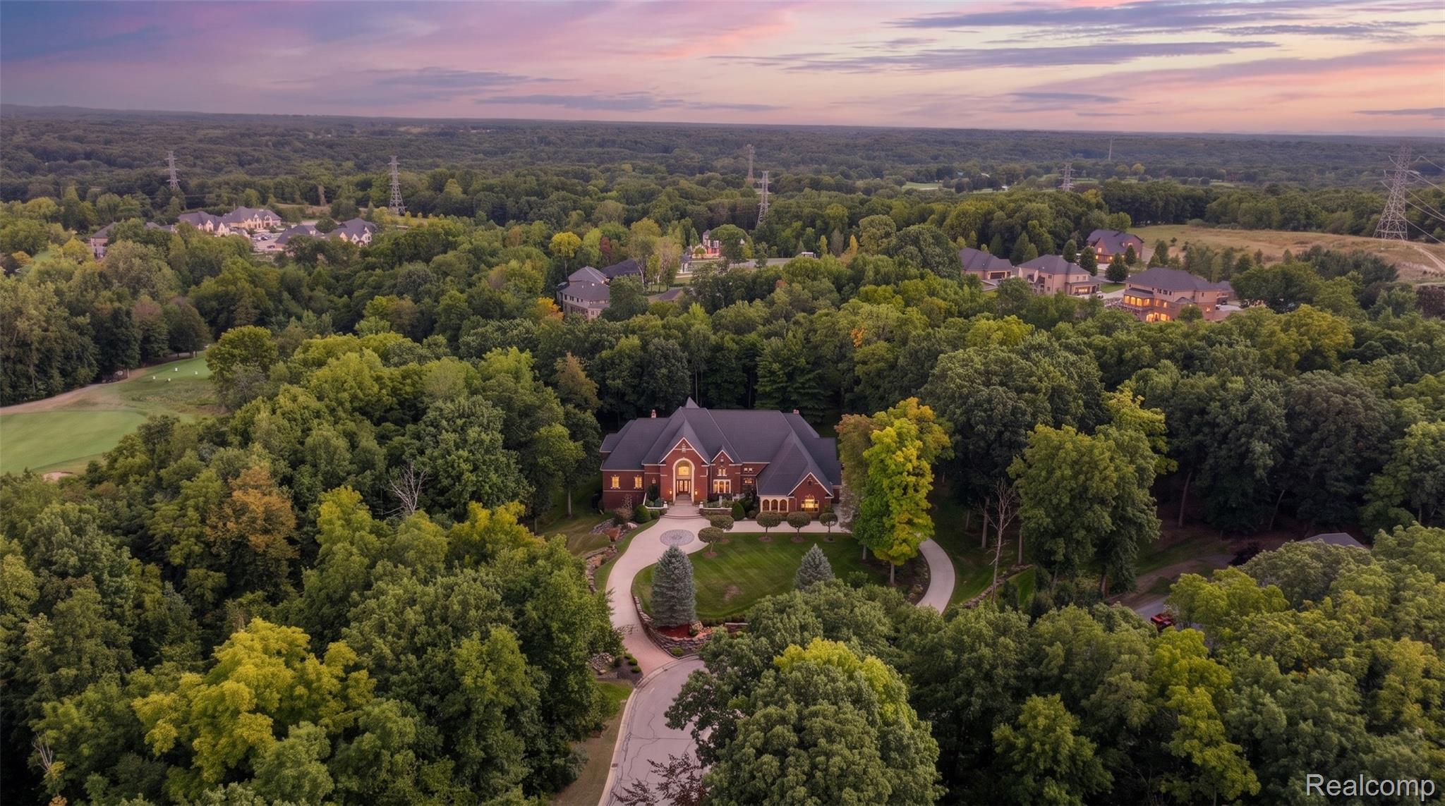 2785 Cranbrook Ridge Court Rochester, MI 48306 - Photo 4 of 99 Expansive property featuring a brick exterior residence, surrounded by mature trees, a circular driveway, and manicured landscaping