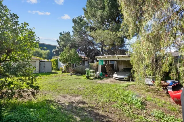 a backyard of a house with table and chairs