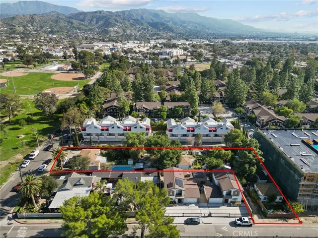 an aerial view of residential houses with outdoor space
