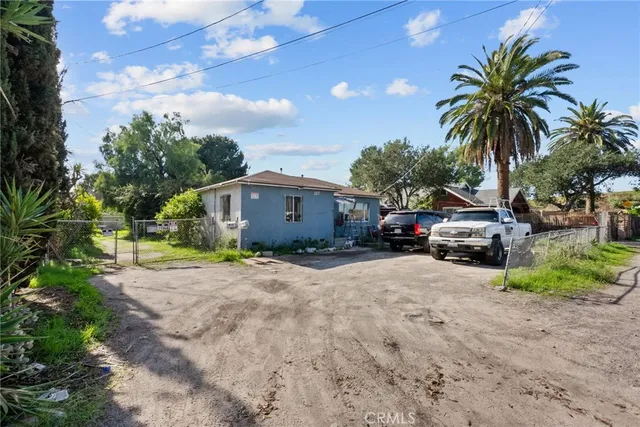 a view of a house with a yard and sitting area