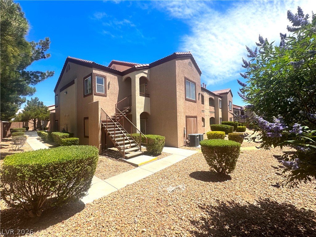 9580 West Reno Avenue, Unit 242 Las Vegas, NV 89148 - Photo 23 of 26 Well-maintained grounds with desert landscaping surround this inviting multi-story residence.
