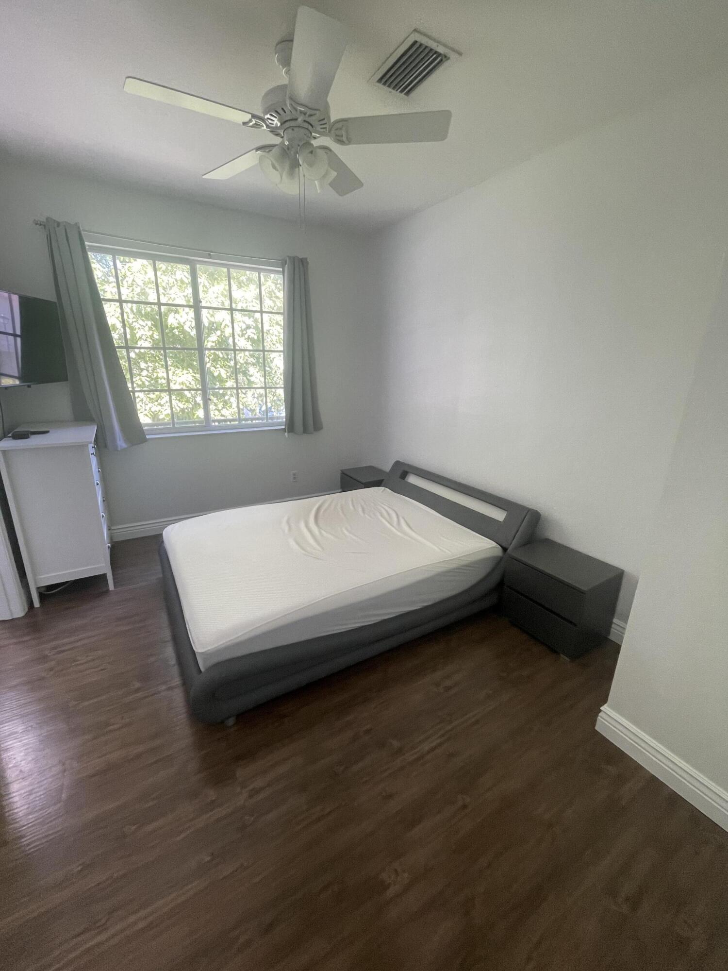 111 Stone Harbor Way, Unit F2 Delray Beach, FL 33444 - Photo 8 of 11 a bedroom with a bed and a window