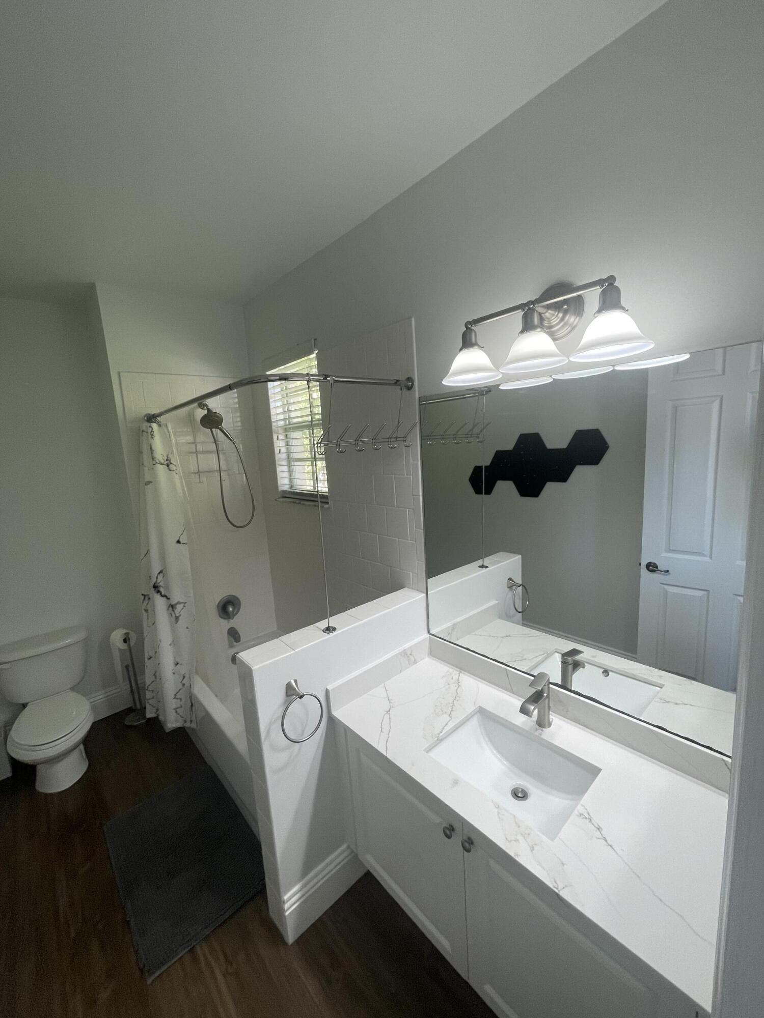 111 Stone Harbor Way, Unit F2 Delray Beach, FL 33444 - Photo 9 of 11 a bathroom with a sink and mirror with toilet