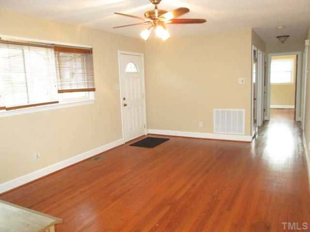 1408 Southerlund Road Garner, NC 27529 - Photo 12 of 25 Living room features refinished gleaming hardwood floors, updated ceiling fan with light kit & 1 inch wood blinds! Lots of new paint throughout home!