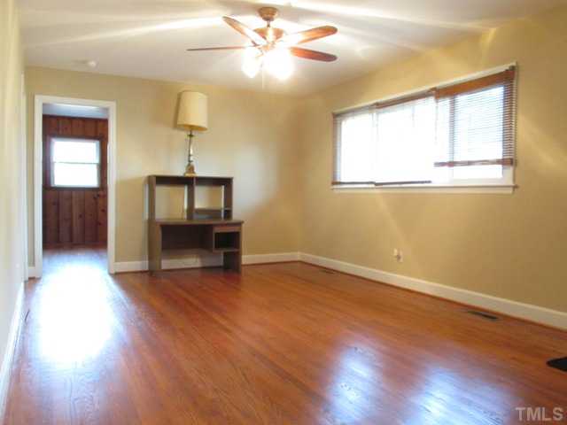1408 Southerlund Road Garner, NC 27529 - Photo 13 of 25 Another view of the living room with beautiful refinished hardwood floors! Door to the left views into the family room/office/play room!