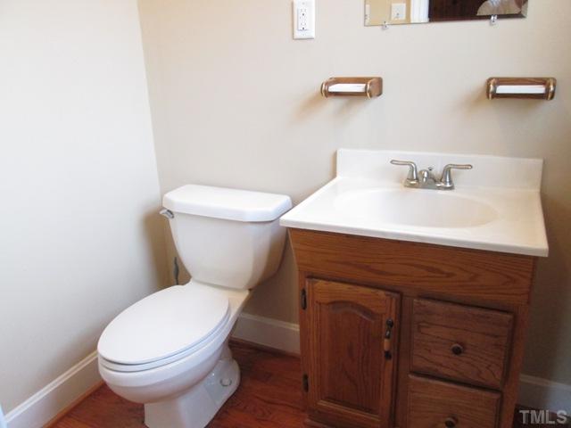 1408 Southerlund Road Garner, NC 27529 - Photo 18 of 25 Half bath features some updates! New faucet, new paint and new GFIC! Lovely hardwood floors!