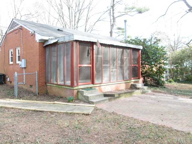 1408 Southerlund Road Garner, NC 27529 - Photo 3 of 25 Wonderful screened porch with a walk in storage area! Could be a workshop! Large brick patio is great for grilling!