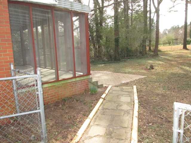 1408 Southerlund Road Garner, NC 27529 - Photo 6 of 25 Another nice view of the screened porch and here you can see the walkway leading to the large brick patio! Nice view of the backyard!