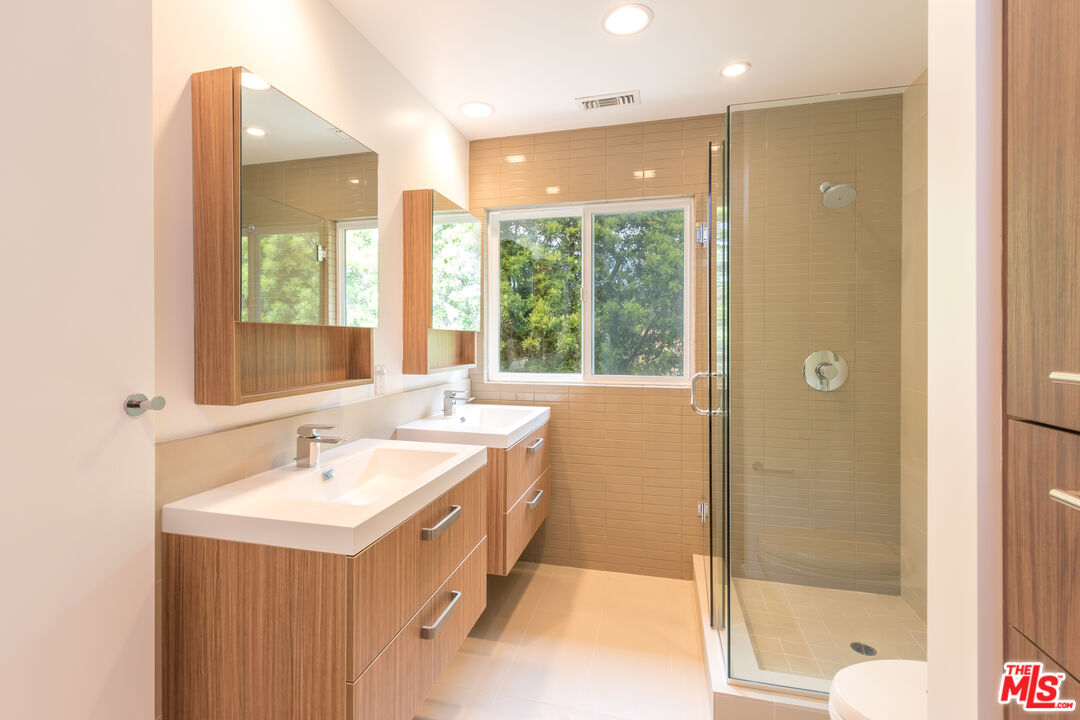 28929 Wight Road Malibu, CA 90265 - Photo 11 of 22 a bathroom with a double vanity sink and a bathtub