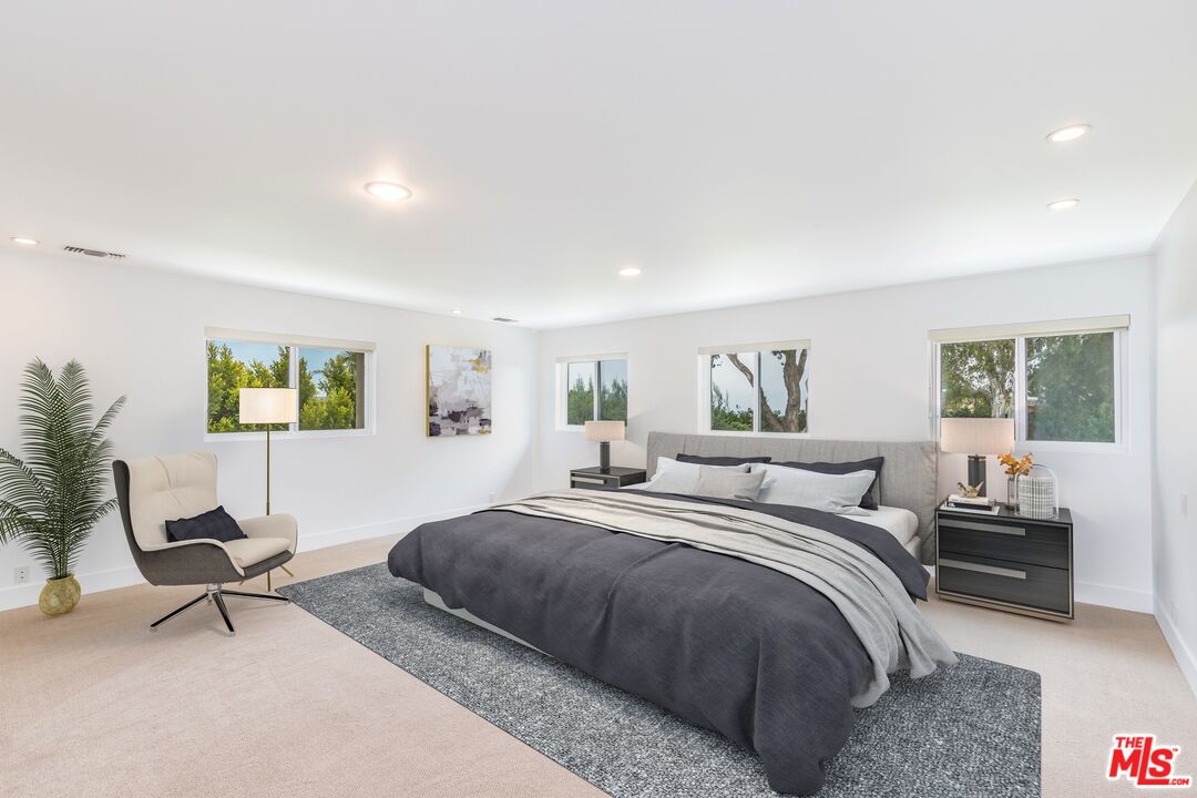 28929 Wight Road Malibu, CA 90265 - Photo 12 of 22 a bedroom with a bed a table and a window