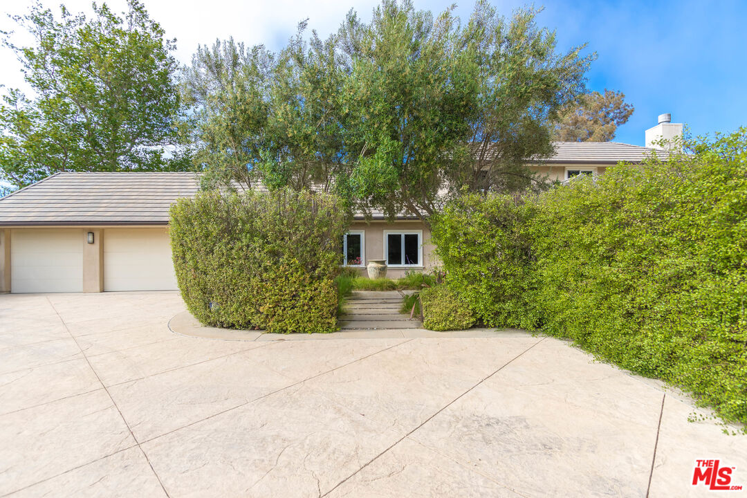 28929 Wight Road Malibu, CA 90265 - Photo 20 of 22 a view of a house with a yard and potted plants