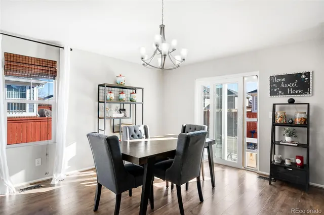 a view of a dining room with furniture wooden floor and a chandelier