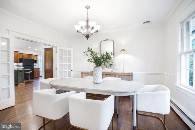 a kitchen with center island table and chairs