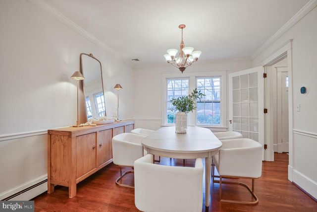 a view of a dining room with furniture wooden floor and chandelier
