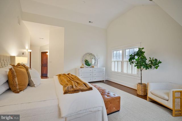 a spacious bedroom with a bed and a window