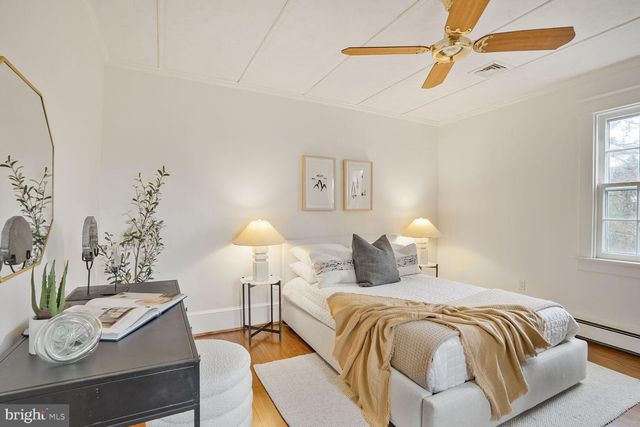 a bedroom with a bed and a lamp