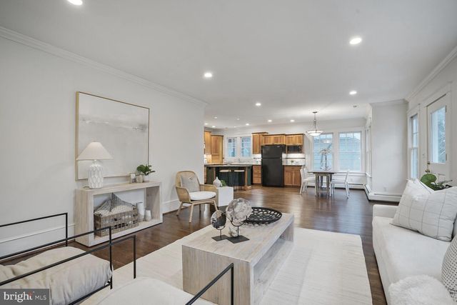 a living room with fireplace furniture and a wooden floor