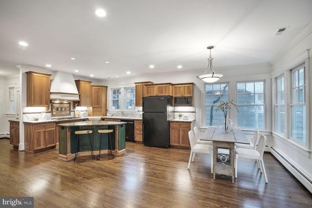 a living room with furniture and view of kitchen