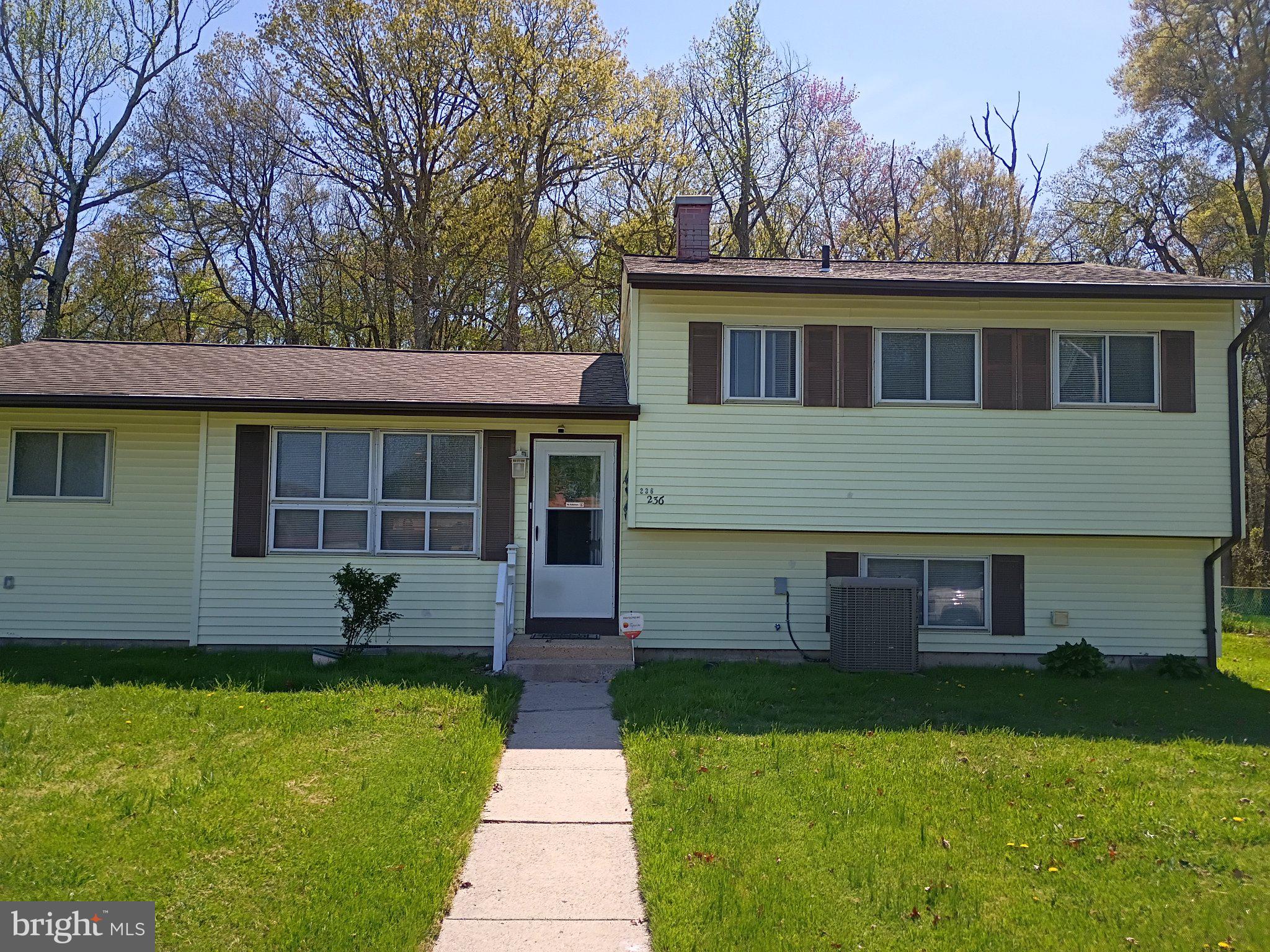 Charming split-level home with greenery.