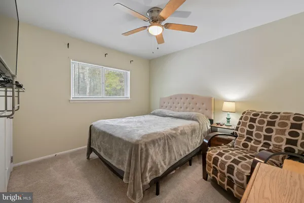 a bedroom with bed and a chandelier