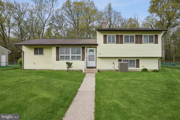 a front view of a house with a garden and yard