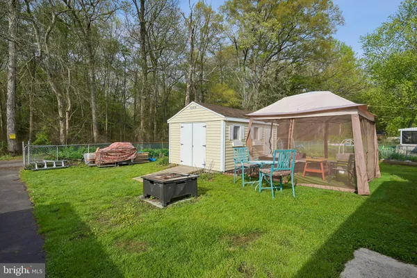 a view of a house with backyard sitting area and garden
