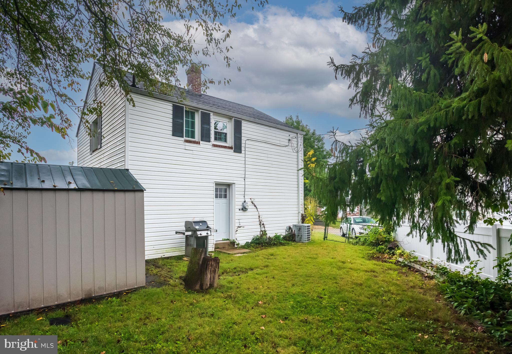 2335 Poe Road Secane, PA 19018 - Photo 14 of 15 a view of a backyard with plants and a large tree