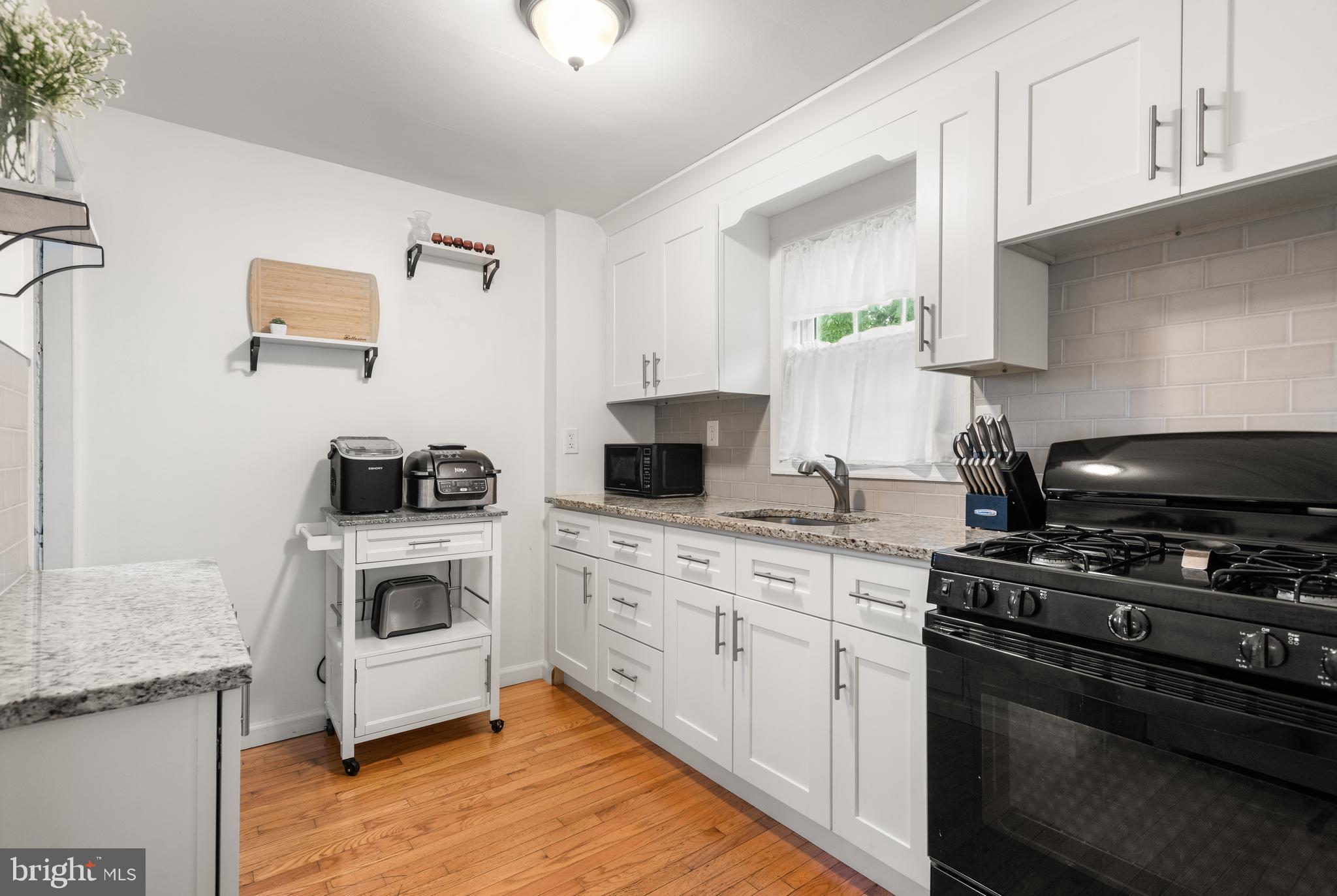 2335 Poe Road Secane, PA 19018 - Photo 7 of 15 a kitchen with a stove and a white cabinets