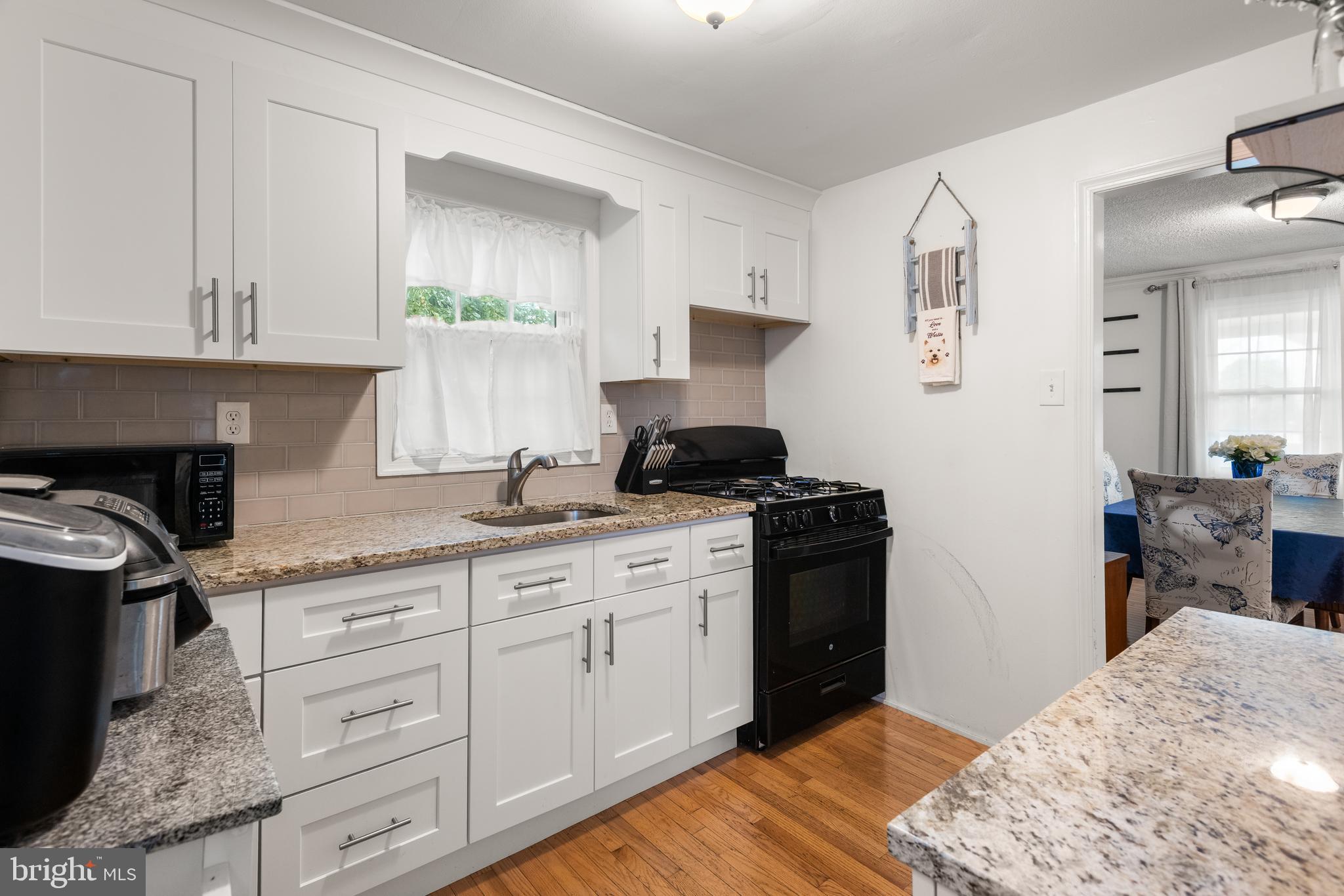 2335 Poe Road Secane, PA 19018 - Photo 8 of 15 a kitchen with granite countertop a sink cabinets stainless steel appliances and a counter space