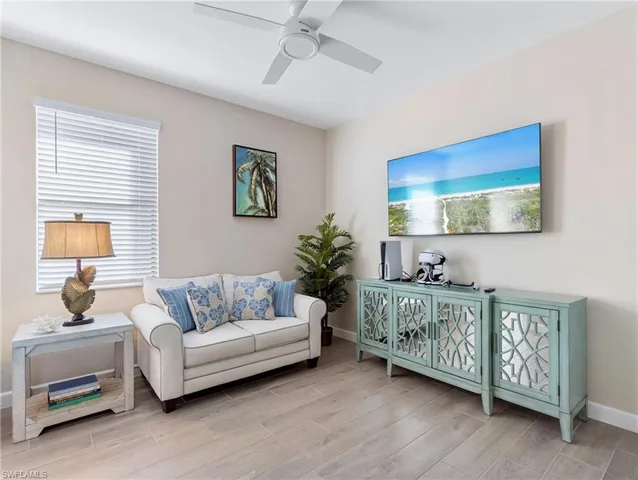 a living room with furniture and a floor to ceiling window