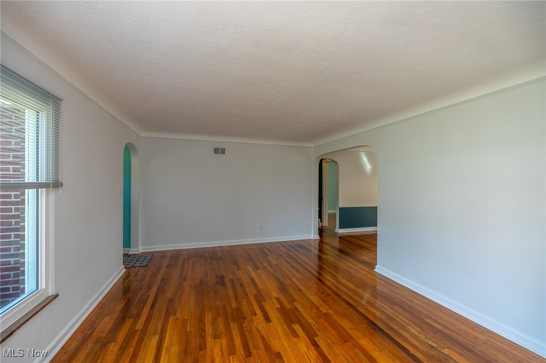 21475 Eaton Road Cleveland, OH 44126 - Photo 21 of 31 Spare room featuring a wealth of natural light, dark hardwood / wood-style floors, and a textured ceiling