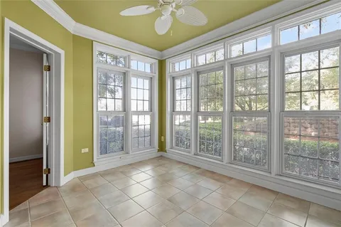 a view of a room with wooden floor and a ceiling fan
