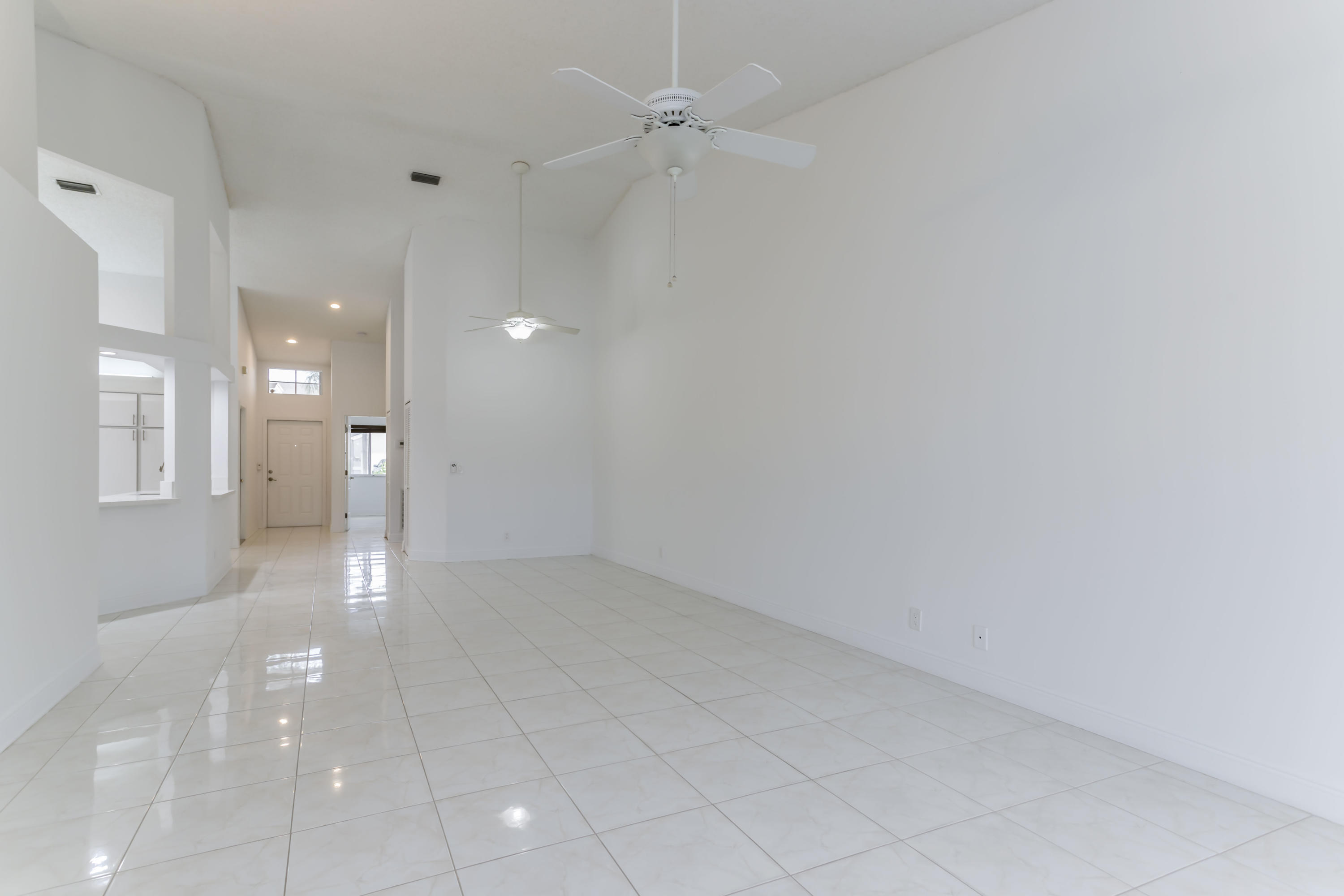 9130 Vineland Court, Unit C Boca Raton, FL 33496 - Photo 11 of 81 an empty room with a natural light and ceiling fan