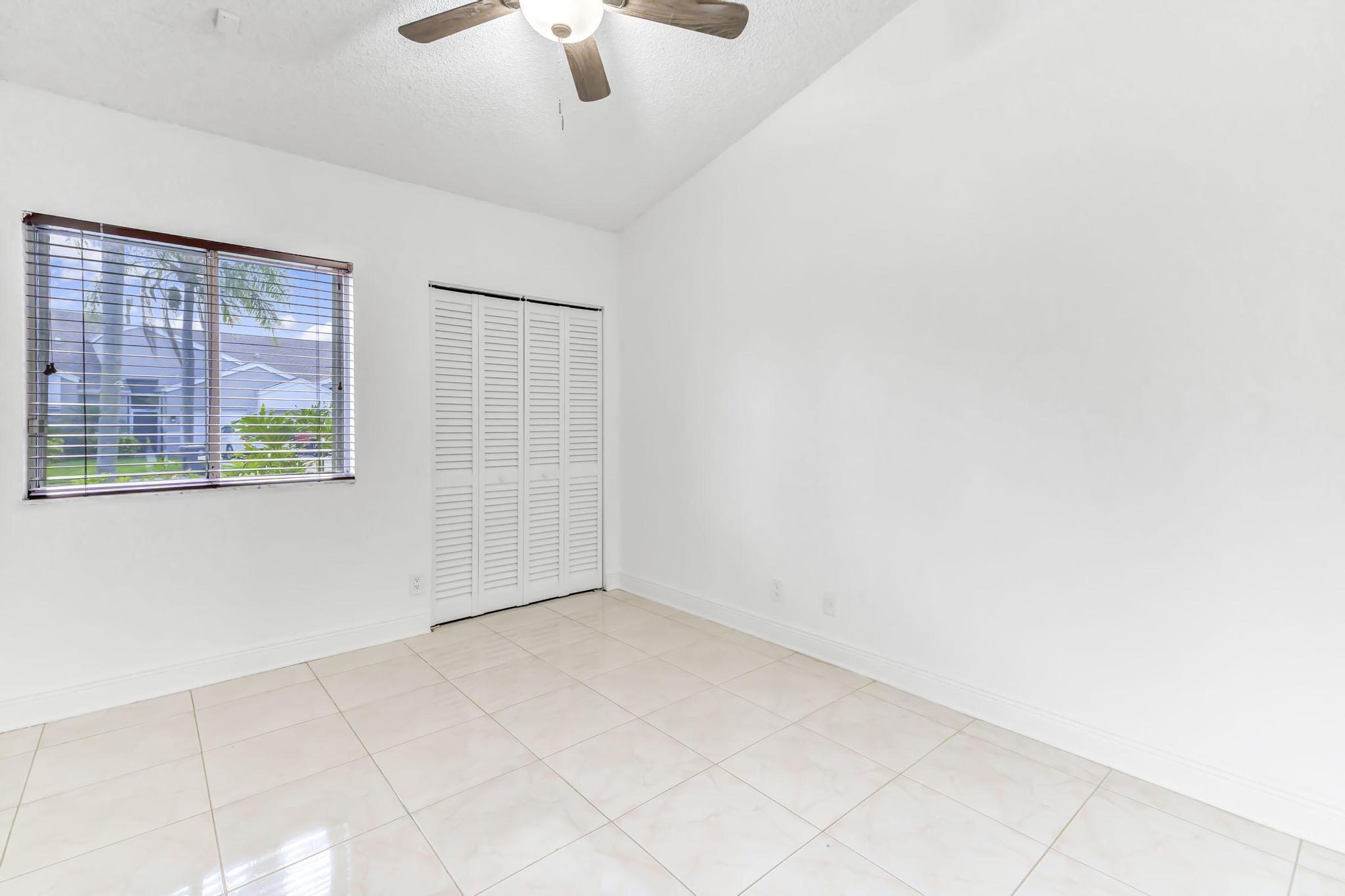 9130 Vineland Court, Unit C Boca Raton, FL 33496 - Photo 28 of 81 an empty room with a empty space and windows