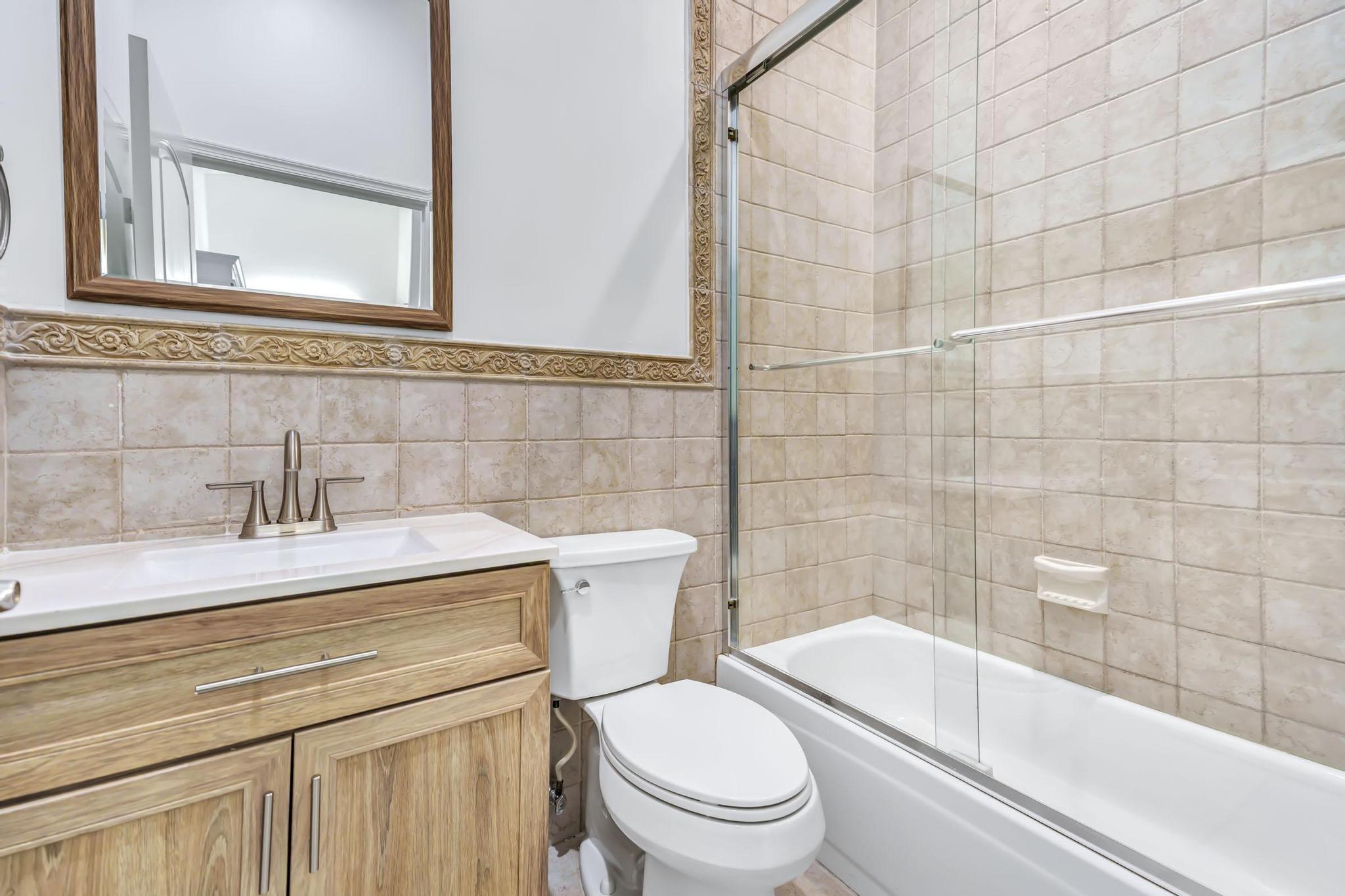 9130 Vineland Court, Unit C Boca Raton, FL 33496 - Photo 29 of 81 a bathroom with a sink a toilet and shower