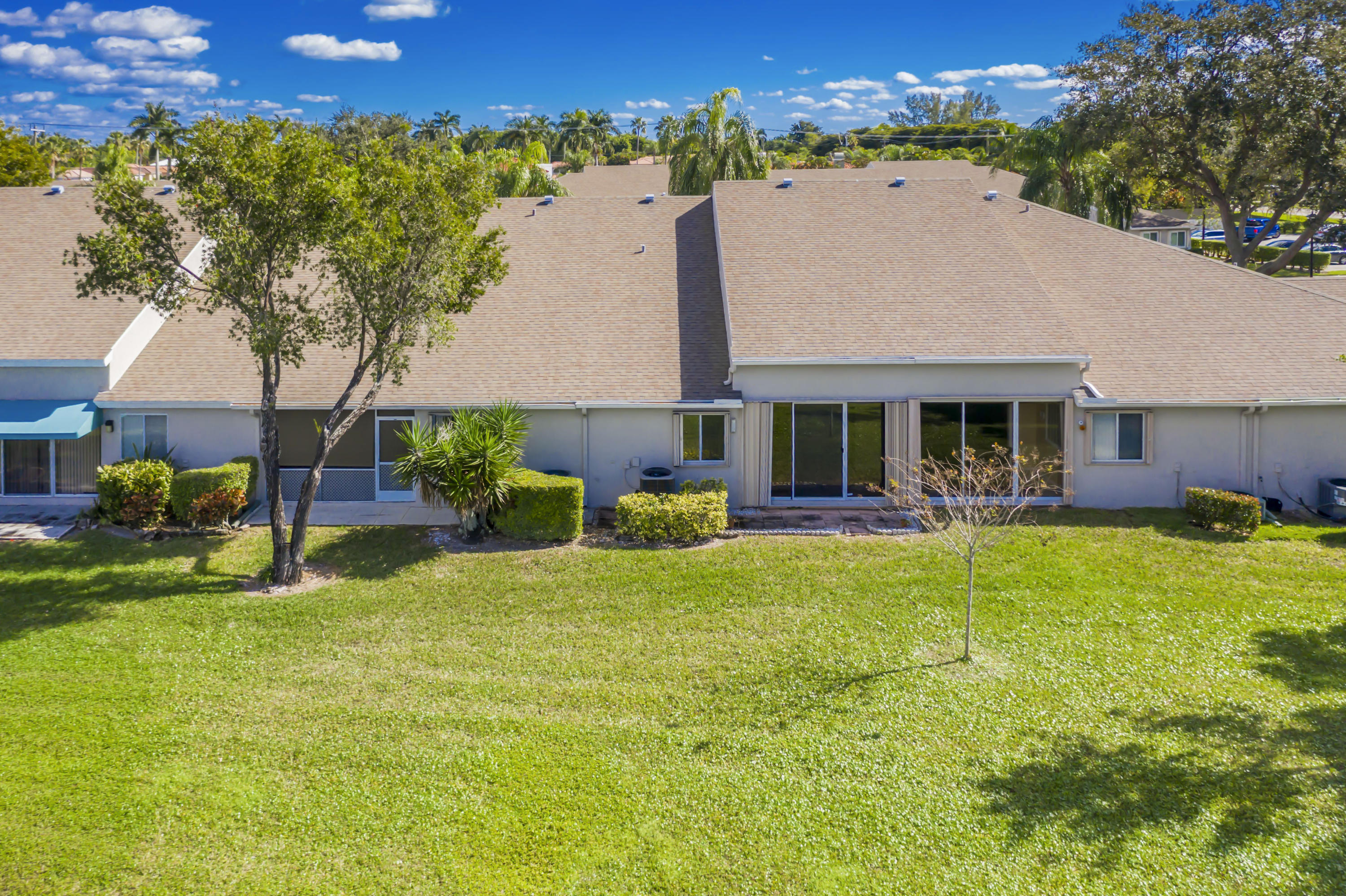 9130 Vineland Court, Unit C Boca Raton, FL 33496 - Photo 31 of 81 a view of house with yard and outdoor seating
