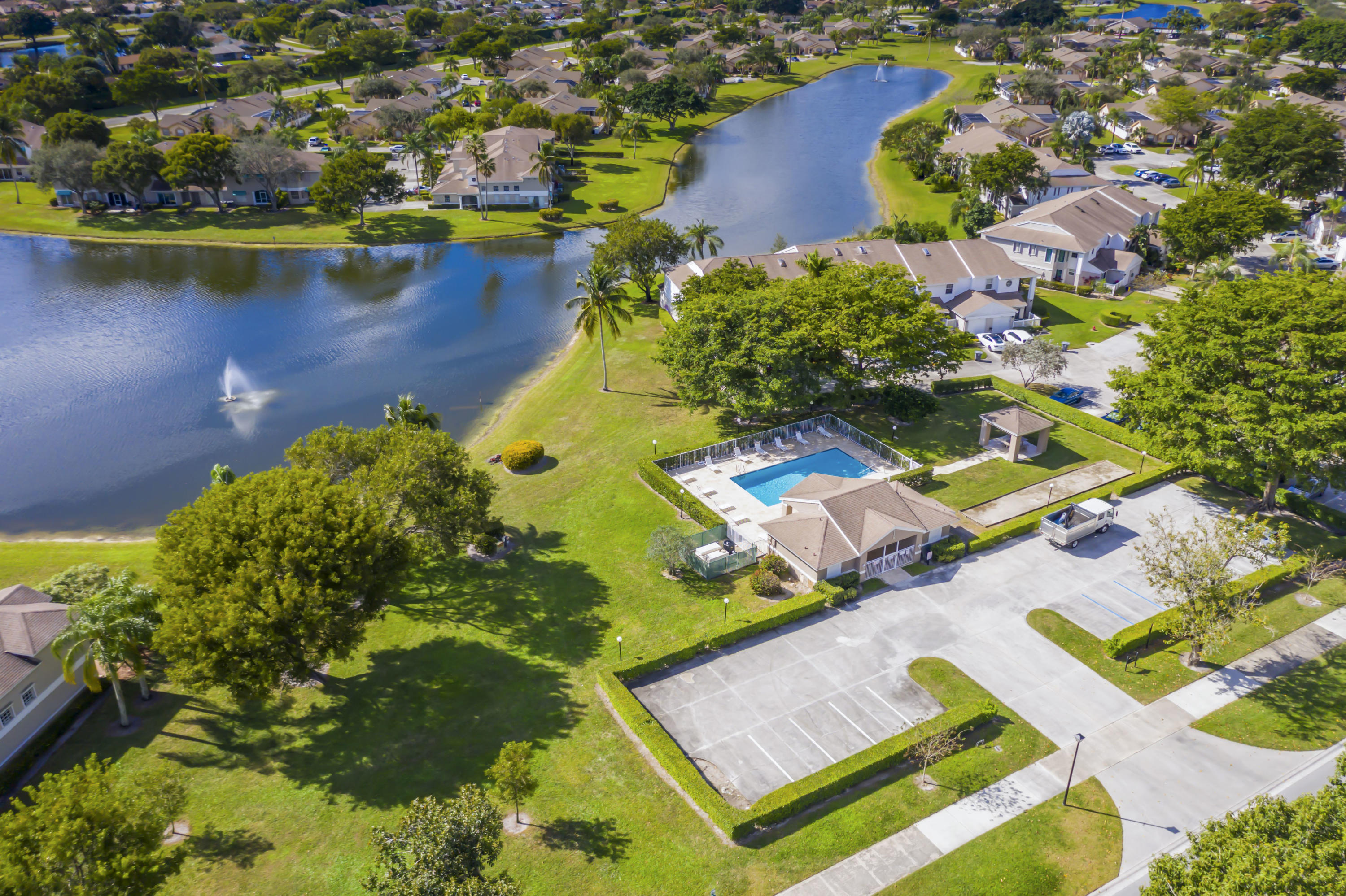 9130 Vineland Court, Unit C Boca Raton, FL 33496 - Photo 35 of 81 an aerial view of a house with a swimming pool yard and lake view