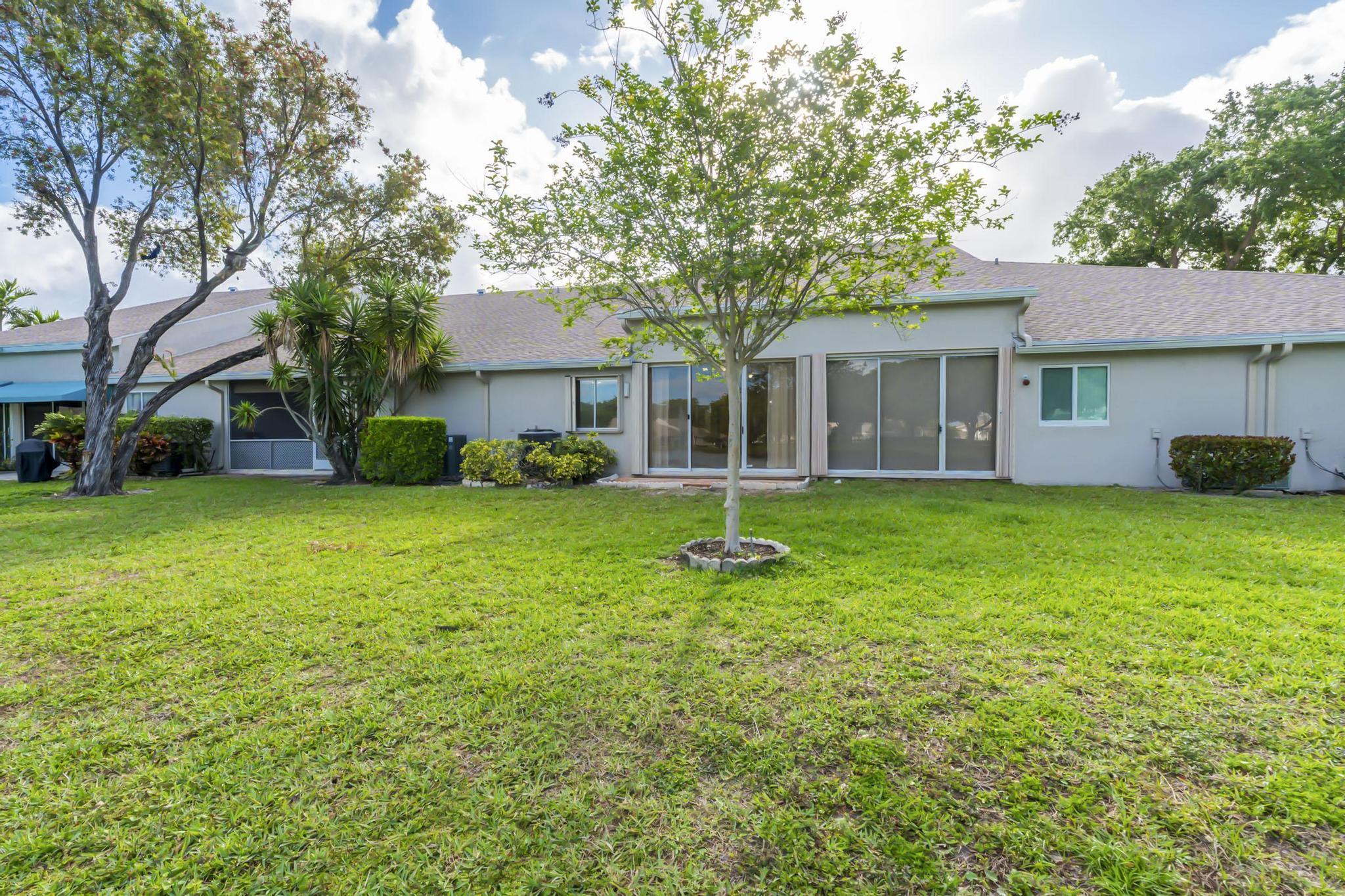 9130 Vineland Court, Unit C Boca Raton, FL 33496 - Photo 49 of 81 a front view of house with yard and green space