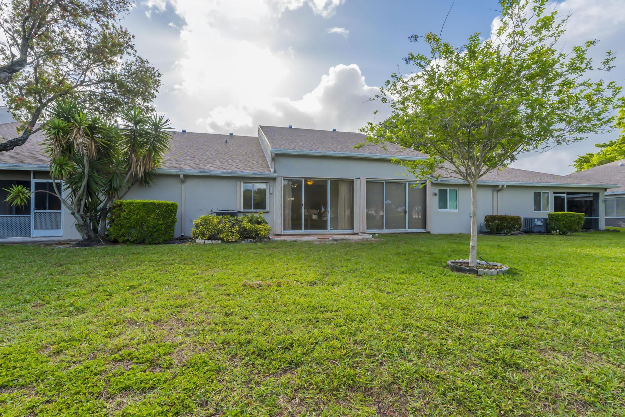 9130 Vineland Court, Unit C Boca Raton, FL 33496 - Photo 50 of 81 a front view of a house with a garden