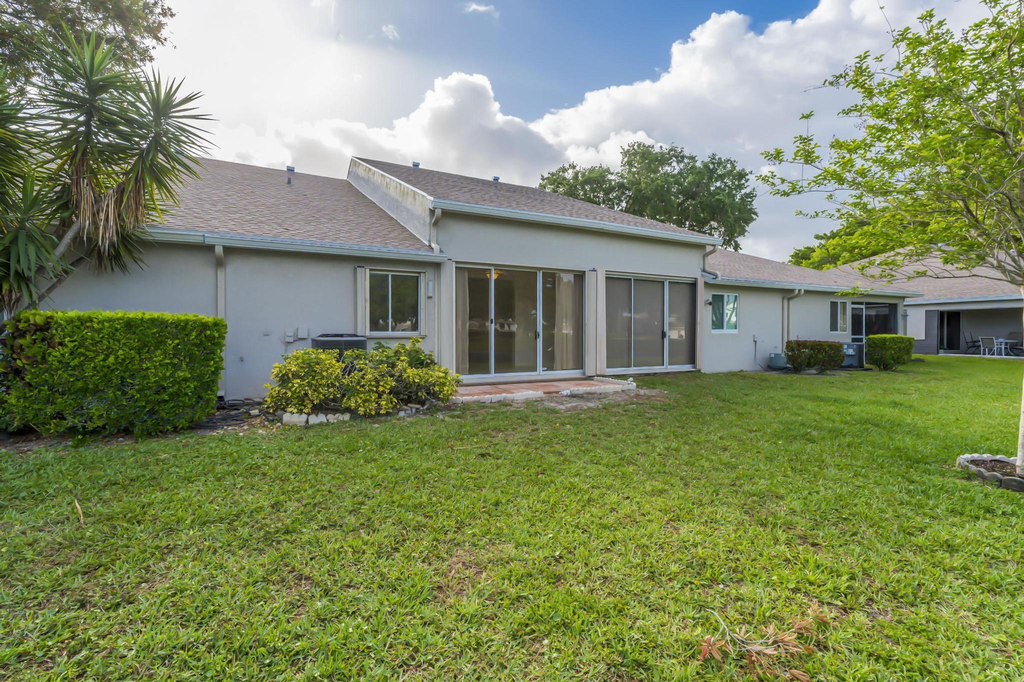 9130 Vineland Court, Unit C Boca Raton, FL 33496 - Photo 51 of 81 a house view with a garden space