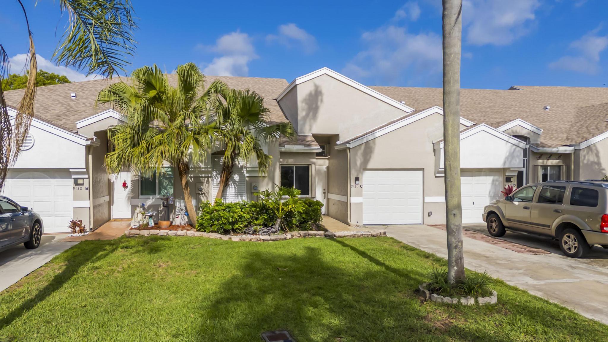 9130 Vineland Court, Unit C Boca Raton, FL 33496 - Photo 54 of 81 a house view with a garden space